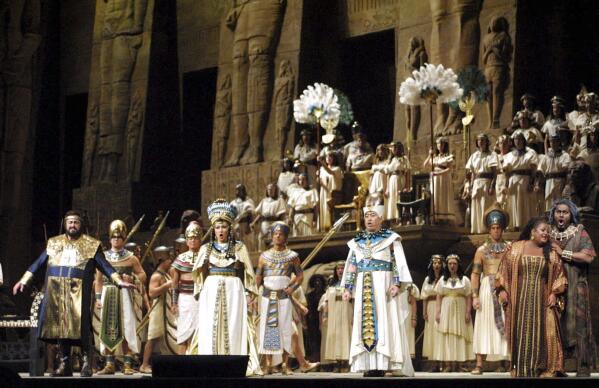 FILE - Luciano Pavarotti, left, as Radames, Olga Borodina, second left, as Princess Amneris, Hao Jiang Tian, third left, as the King, Deborah Voigt, second right, as Aida, and Mark Delavan, right, as Amonasro, perform during a dress rehearsal of Giuseppe Verdi's "Aida" Friday, Jan. 12, 2001, at New York's Metropolitan Opera. Sonja Frisell's staging of Verdi's `Aida' ends its 35-year-run at Metropolitan Opera on Thursday. A new version by Tony Award winner Michael Mayer is to open in 2024-25. (AP Photo/Robert Mecea, File)