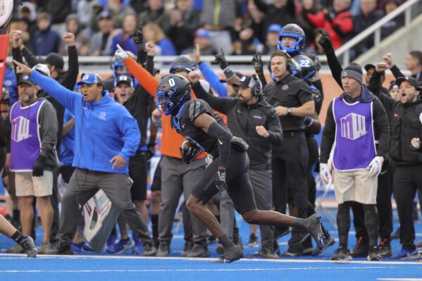 Boise State safety JL Skinner (0) turns upfield after intercepting a BYU pass in the first half of an NCAA college football game, Saturday, Nov. 5, 2022, in Boise, Idaho. (AP Photo/Steve Conner)