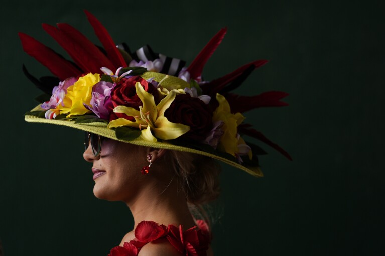 A race fan watches race at Churchill Downs before the 150th running of the Kentucky Derby horse race Saturday, May 4, 2024, in Louisville, Ky. (AP Photo/Brynn Anderson)
