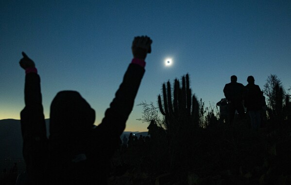 FILE - People view a total solar eclipse from La Higuera, Chile, Tuesday, July 2, 2019. (AP Photo/Esteban Felix, File)