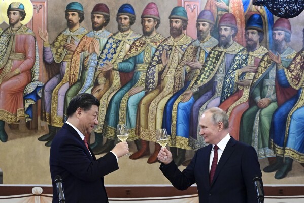 FILE - Russian President Vladimir Putin, right, and Chinese President Xi Jinping toast during their dinner at The Palace of the Facets, a building in the Moscow Kremlin, Russia, on March 21, 2023. President Vladimir Putin is likely to win another six-year term easily in an election expected in March, using his sweeping grip on Russia’s political scene to extend his tenure of over two decades in power. But he faces daunting challenges. (Pavel Byrkin, Sputnik, Kremlin Pool Photo via AP, File)