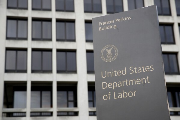 FILE - A sign stands outside the U.S. Department of Labor's headquarters, May 6, 2020, in Washington. The U.S. Department of Labor’s Occupational Safety and Health Administration found numerous safety violations in its investigation of the July 2023 workplace accident that caused the death of Duvan Pérez, a Guatemalan teenager who had been a contract worker at the Mar-Jac Poultry plant in Hattiesburg, Miss., the agency said in a news release on Tuesday, Jan. 16, 2024. (AP Photo/Patrick Semansky, File)