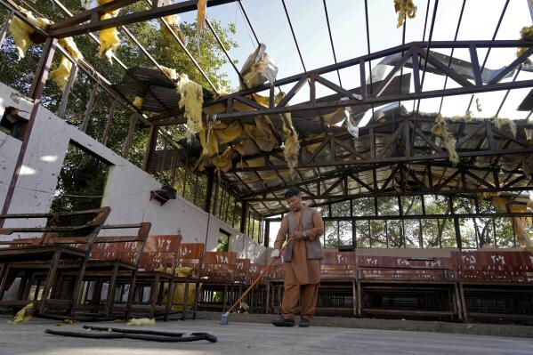 A man cleans a Hazara education center that was destroyed in Friday's suicide bombing in Kabul, Afghanistan, Saturday, Oct. 1, 2022. Last week’s suicide bombing at the Kabul education center killed as many as 52 people, more than double the death toll acknowledged by Taliban officials, according to a tally compiled by The Associated Press on Monday. Dozens more were injured in Friday's blast, making it one of the bloodiest attacks since the Taliban seized control of Afghanistan more than a year ago. (AP Photo/Ebrahim Noroozi)