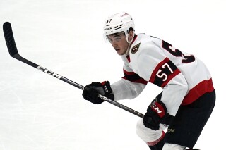 FILE - Ottawa Senators center Shane Pinto (57) plays during an NHL hockey game against the Bosotn Bruins Tuesday, March 21, 2023, in Boston. Pinto, the first modern NHL player suspended for gambling, spoke to reporters in Ottawa for the first time, Friday, Jan. 12, 2024, since the half-season ban was handed down in October,. Pinto is eligible to play as soon as Jan. 21 at Philadelphia, the Senators' 42nd game, but needs to sign a contract first. (AP Photo/Charles Krupa, File)