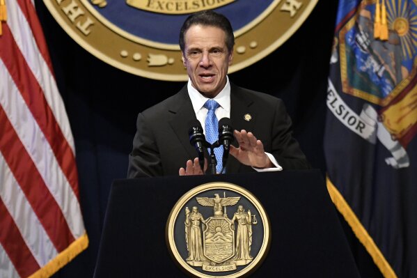 FILE - In this Jan. 8, 2020, file photo, New York Gov. Andrew Cuomo delivers his State of the State address at the Empire State Plaza Convention Center, in Albany, N.Y.  New York state is shuttering several schools and houses of worship for two weeks in a suburb and sending in the National Guard to help with what appears to be the nation's biggest cluster of cases of the coronavirus, Cuomo said Tuesday, March 10.  (AP Photo/Hans Pennink, File)