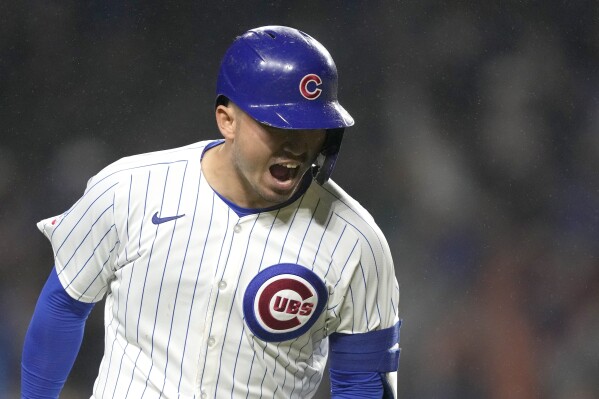 Chicago Cubs' Seiya Suzuki begins to celebrate his grand slam off Cincinnati Reds starting pitcher Hunter Greene during the second inning of a baseball game Saturday, June 1, 2024, in Chicago. (AP Photo/Charles Rex Arbogast)