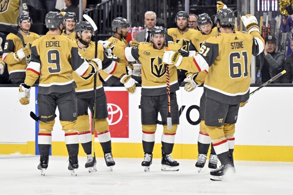 Vegas Golden Knights right wing Jonathan Marchessault, center, celebrates after his power play goal against the Winnipeg Jets during the second period of an NHL hockey game Thursday, Nov. 2, 2023, in Las Vegas. (AP Photo/David Becker)