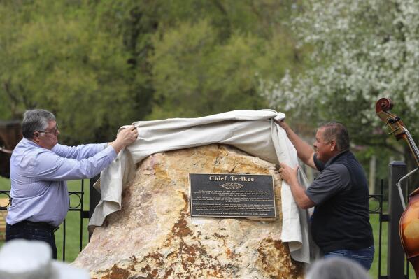 Former Northwestern Band of Shoshone Chairman Darren Parry, right, is shown in Harrisville, Utah, on Saturday, May 1, 2021, unveiling a monument. The monument marked the spot Shoshone Chief Terikee was killed by a pioneer settler in Harrisville along with Stewart Cowley, a descendent of a pioneer who killed him. (Emily Anderson/Standard-Examiner via AP)