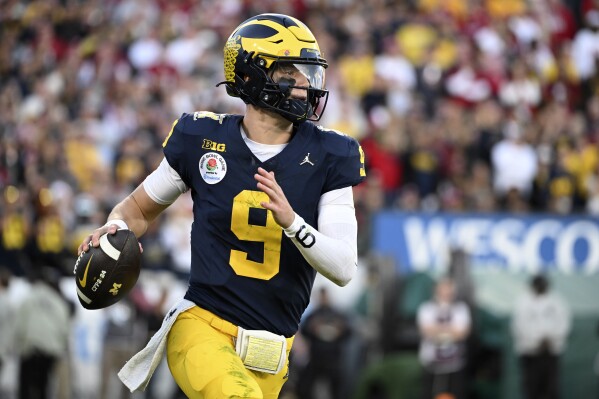 FILE - Michigan quarterback J.J. McCarthy (9) rolls out during the second half of the Rose Bowl CFP NCAA semifinal college football game against Alabama Monday, Jan. 1, 2024, in Pasadena, Calif. McCarthy is a possible first round pick in the NFL Draft.(AP Photo/Kyusung Gong, File)