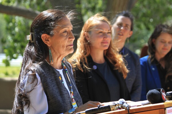 U.S. Interior Secretary Deb Haaland, left, is flanked by U.S. Rep. Melanie Stansbury, D-N.M., and state and local water officials during a news conference in Albuquerque, N.M., Friday, May 10, 2024. Haaland announced the federal government is dedicating $60 million for conservation projects along the Rio Grande, marking the first distribution of funding under the Inflation Reduction Act for a basin outside of the Colorado River system. (AP Photo/Susan Montoya Bryan)