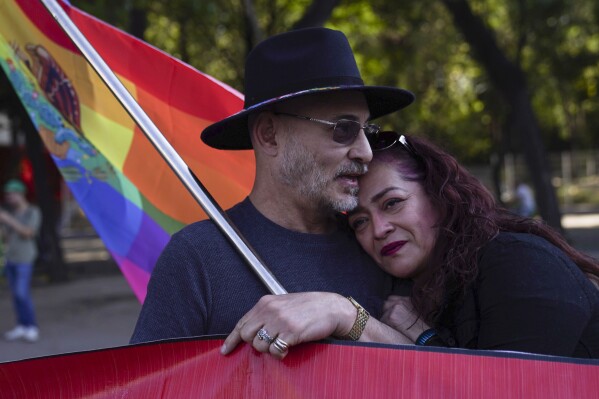 Adolfo Voorduin, left, and Nancy Martinez embrace during a rally by members of the LGBTQ+ community to protest the murder of transgender activist Samantha Gomes Fonseca in Mexico City, Monday, Jan. 15, 2024. Gomes was shot in Mexico City Sunday. (AP Photo/Marco Ugarte)