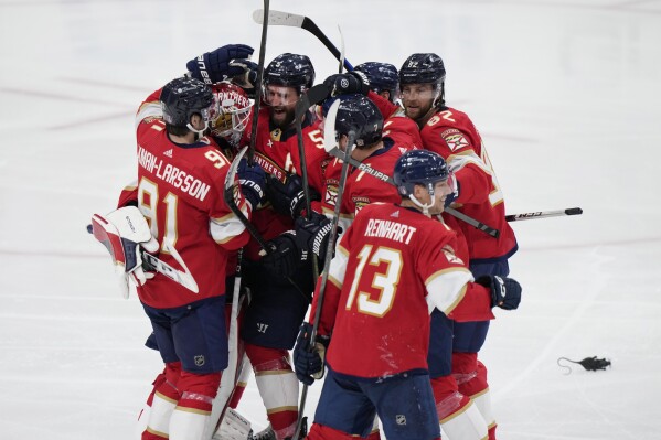 Florida Panthers players celebrate after beating the Tampa Bay Lightning 3-2 during an overtime period of Game 2 of the first-round of an NHL Stanley Cup Playoff series, Tuesday, April 23, 2024, in Sunrise, Fla. (AP Photo/Wilfredo Lee)