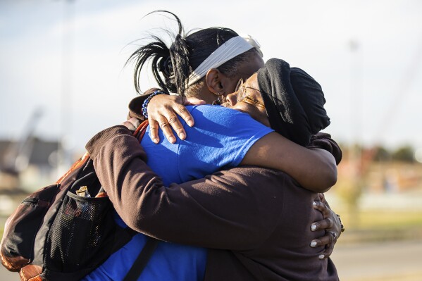 Sheneen McClain, right, mother of Elijah McClain, and friend and supporter MiDian Holmes embrace after suspended Aurora, Colo., Police officer Nathan Woodyard was acquitted in the 2019 death of Elijah, outside of the Adams County Justice Center on Monday, Nov. 6, 2023, in Brighton, Colo. (Hart Van Denburg/Colorado Public Radio via AP)