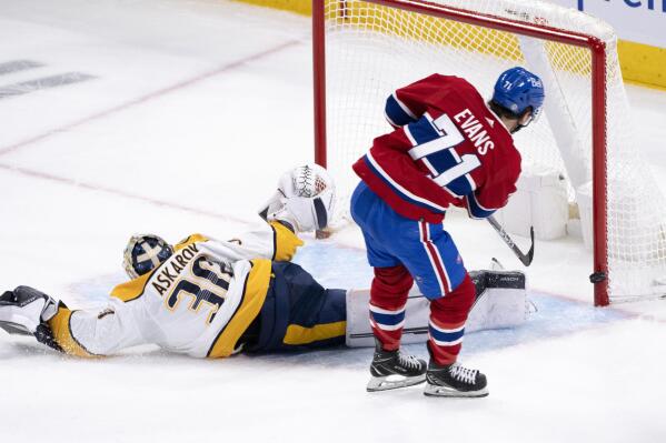 Montreal Canadiens' Jake Evans, right, hits the goalpost behind Nashville Predators goaltender Yaroslav Askarov with the puck during second-period NHL hockey game action in Montreal, Thursday, Jan. 12, 2023. (Paul Chiasson/The Canadian Press via AP)