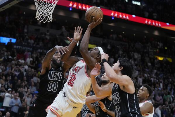 Miami Heat forward Jimmy Butler (22) attempts a shot during final seconds of the second half of an NBA basketball game against the Brooklyn Nets, Sunday, Jan. 8, 2023, in Miami. (AP Photo/Wilfredo Lee)