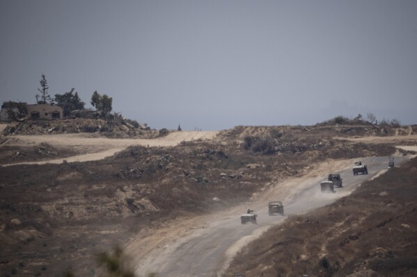 Israeli soldiers move near the Israeli-Gaza border as seen from southern Israel, Monday, June 10, 2024. (AP Photo/Leo Correa)
