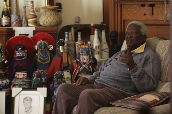 File - South African photographer Peter Magubane, speaks with The Associated Press during an interview at his home, in Johannesburg, Thursday June 2, 2016. Magubane, a fearless photographer who captured the violence and horror of South Africa’s brutal apartheid era of racial oppression and was then entrusted with documenting Nelson Mandela’s first years of freedom after his release from prison, has died. He was 91. The South African National Editors’ Forum said it had been informed by Magubane's family that he died on Monday, Jan. 1, 2024. (AP Photo/Denis Farrell, File)