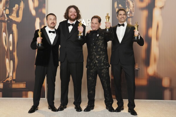 From left, Gints Zilbalodis, Matiss Kaza, Ron Dyens and Gregory Zalcman, winners of the award for best animated feature film for "Flow," pose in the press room at the Oscars on Sunday, March 2, 2025, at the Dolby Theatre in Los Angeles. (Photo by Jordan Strauss/Invision/AP)