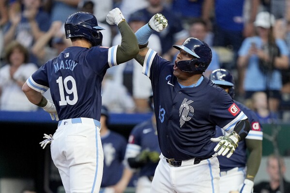 Kansas City Royals' Michael Massey (19) celebrates with Salvador Perez (13) after hitting a two-run home run during the sixth inning of a baseball game against the Oakland Athletics Friday, May 17, 2024, in Kansas City, Mo. (AP Photo/Charlie Riedel)