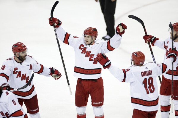 Carolina Hurricanes center Martin Necas (88) celebrates with teammates after scoring an empty-net goal in the third period during Game 5 of an NHL hockey Stanley Cup second-round playoff series against the New York Rangers, Monday, May 13, 2024, in New York. (AP Photo/Adam Hunger)