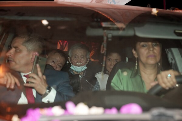 Peru's former President Alberto Fujimori, 85, center, is driven out of prison by his children Keiko, center right, and Kenji, center left, after being released from prison in Callao, Peru, Wednesday, Dec. 6, 2023. The country's constitutional court ordered an immediate humanitarian release on Tuesday for the former leader who was serving a 25-year sentence for human rights abuses. (AP Photo/Martin Mejia)