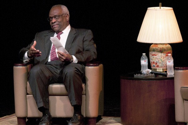 Supreme Court Justice Clarence Thomas holds his notes for his speech at the University of Texas at Tyler Cowan Center on Sept. 16, 2014. (AP Photo/Tyler Morning Telegraph, Herb Nygren Jr., File)