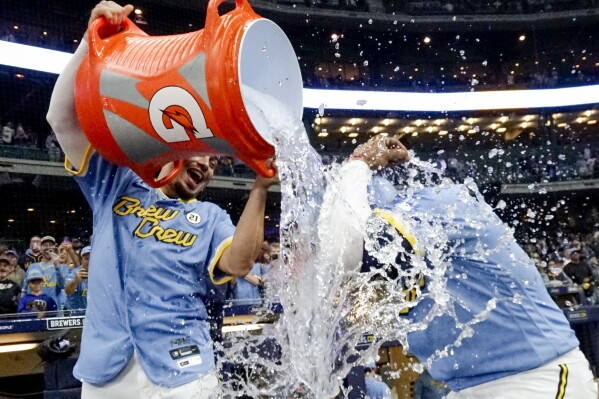 Milwaukee Brewers' Willy Adames douses Carlos Santana after a baseball game against the Washington Nationals Friday, Sept. 15, 2023, in Milwaukee. The Brewers won 5-3. (AP Photo/Morry Gash)