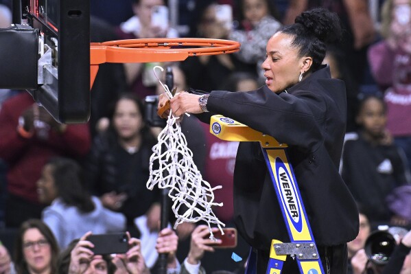 South Carolina head coach Dawn Staley cuts down the net after defeating Oregon State in an Elite Eight round college basketball game during the NCAA Tournament, Sunday, March 31, 2024, in Albany, N.Y. (AP Photo/Hans Pennink)