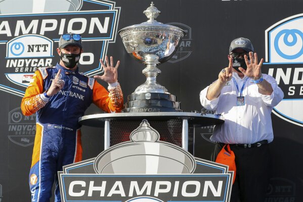 FILE - Driver Scott Dixon, left, and team owner Chip Ganassi celebrate after winning the NTT IndyCar Series Championship following an IndyCar auto race in St. Petersburg, Fla., in this Sunday, Oct. 25, 2020, file photo. The upcoming IndyCar season will be headlined by the six-time IndyCar champion. (AP Photo/Mike Carlson, File)