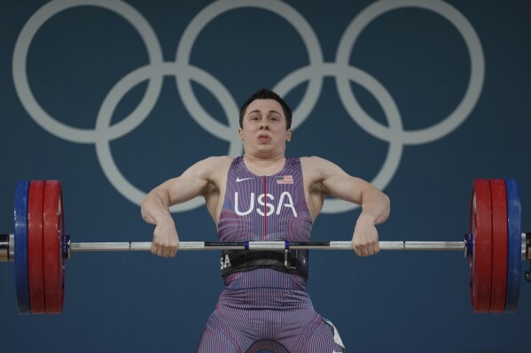 Hampton Morris of the United States competes during the men's 61kg weightlifting event at the 2024 Summer Olympics, Wednesday, Aug. 7, 2024, in Paris, France. (AP Photo/Kin Cheung)