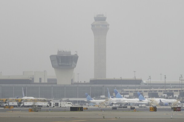 Fog covers planes and control towers at Newark Liberty International Airport in Newark, N.J., Monday, May 5, 2025. (AP Photo/Seth Wenig)