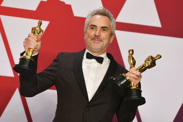 
              Alfonso Cuaron poses with the awards for best director for "Roma", best foreign language film for "Roma", and best cinematography for "Roma" in the press room at the Oscars on Sunday, Feb. 24, 2019, at the Dolby Theatre in Los Angeles. (Photo by Jordan Strauss/Invision/AP)
            