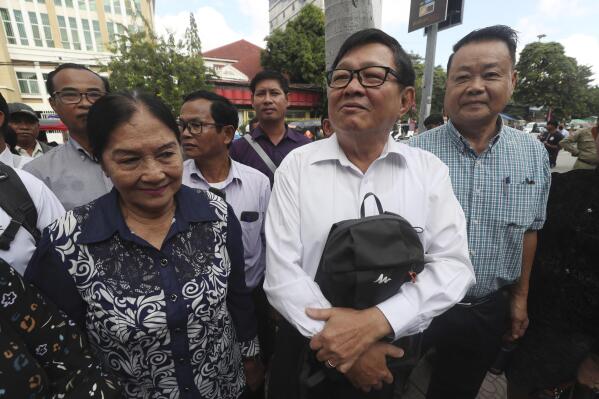 FILE - Son Chhay, second from right, deputy leader of the opposition political Candlelight Party, arrives at the Phnom Penh Municipal Court, in Phnom Penh, Cambodia, Friday, Oct. 7, 2022. Cambodia’s National Election Committee has announced that 20 political parties have registered for the general election in July 2023 but nine of them still have not been approved, including the Candlelight Party, the sole credible challenger to the governing Cambodian People’s Party.(AP Photo/Heng Sinith)