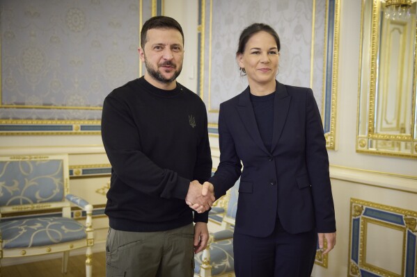 In this photo provided by the Ukrainian Presidential Press Office, Ukrainian President Volodymyr Zelenskyy, left, shakes hands with German Foreign Minister Annalena Baerbock in Kyiv, Ukraine, Tuesday, May 21, 2024. (Ukrainian Presidential Press Office via AP)