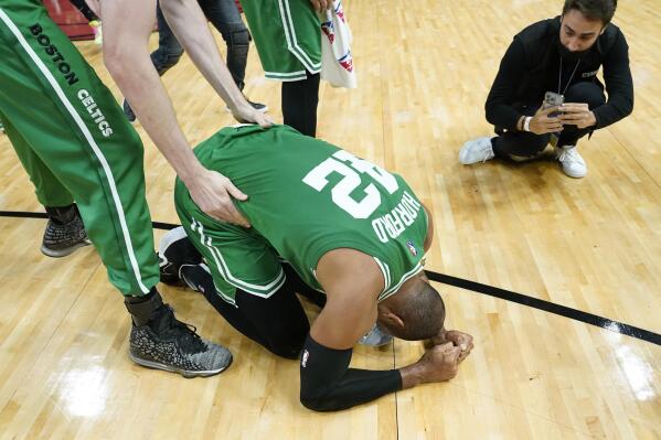 Boston Celtics center Al Horford (42) falls to his knees after winning Game 7 of the NBA basketball Eastern Conference finals playoff series against the Miami Heat, Sunday, May 29, 2022, in Miami. (AP Photo/Lynne Sladky)