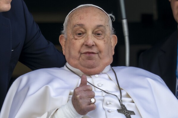 Pope Francis appears at a window of the Agostino Gemelli Polyclinic in Rome, Sunday, March 23, 2025, where he has been treated for bronchitis and bilateral pneumonia since Feb. 14. (AP Photo/Domenico Stinellis)