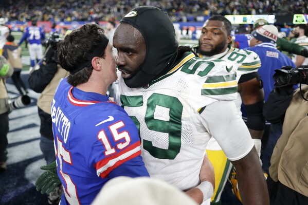 New York Giants quarterback Tommy DeVito (15) talks with Green Bay Packers linebacker De'Vondre Campbell (59) after an NFL football game, Monday, Dec. 11, 2023, in East Rutherford, N.J. (AP Photo/Adam Hunger)