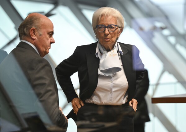 Christine Lagarde, right, President of the European Central Bank (ECB), arrives for a press conference together with Vice President Luis de Guindos, left, at the ECB headquarters in Frankfurt, Germany, Thursday, April 11, 2024. The European Central Bank is leaving its key interest rate benchmark unchanged, choosing to wait for confirmation that rapidly receding inflation is firmly under control before cutting rates to support an economy that’s struggling to grow. (Arne Dedert/dpa via AP)