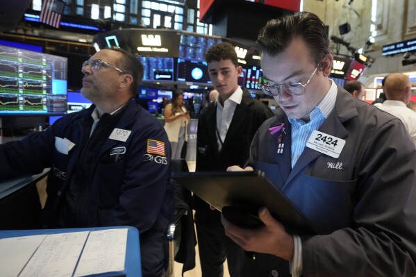 FILE - Trader William Lovesick, right works on the floor of the New York Stock Exchange, June 12, 2024. Shares have opened mixed in Europe on Monday, June 17, 2024, as markets recovered from shocks of recent elections across the region. (AP Photo/Richard Drew, File)