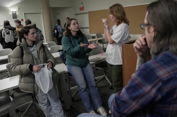 Students Ashley Berson, from left, Olivia Schenker and Zella Milfred talk as instructor Eli Suzukovich III, right, listens following a class on maple syrup and climate change, Friday, Feb. 23, 2024, at Northwestern University in Evanston, Ill. It’s a class that the students, who come from a variety of majors, say is providing hands-on experience in data collection and a front-row seat to witness climate change. (AP Photo/Joshua A. Bickel)