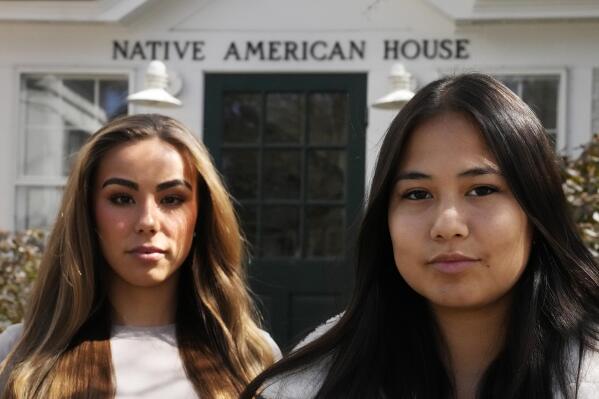 Dartmouth College students Marisa Joseph, right, a member of the Tulalip Tribes of Washington, poses with Ahnili Johnson-Jennings, left, a member of the Quapaw, Choctaw, Sac and Fox and Miami tribes, pose outside the Native American House at Dartmouth College, Friday, April 7, 2023, in Hanover, N.H. The college announced in March 2023 that it housed partial Native American skeletal remains in their collection. Dartmouth has set in motion an effort to repatriate the remains to the appropriate tribes. (AP Photo/Charles Krupa)