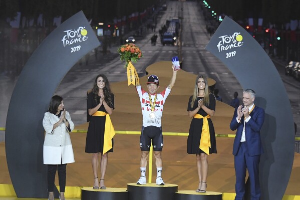 Australia's Caleb Ewan celebrates on the podium after winning the twenty-first stage of the Tour de France cycling race over 128 kilometers (79.53 miles) with start in Rambouillet and finish in Paris, France, July 28, 2019. (Stephane Mantey, Pool Photo via AP, file)