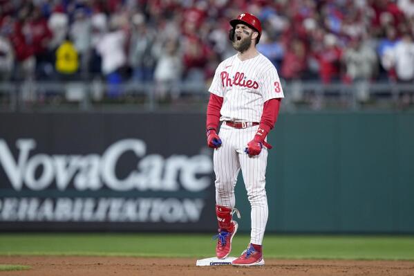 Philadelphia Phillies' Bryce Harper celebrates after his RBI-double during the fifth inning in Game 4 of the baseball NL Championship Series between the San Diego Padres and the Philadelphia Phillies on Saturday, Oct. 22, 2022, in Philadelphia. (AP Photo/Matt Rourke)