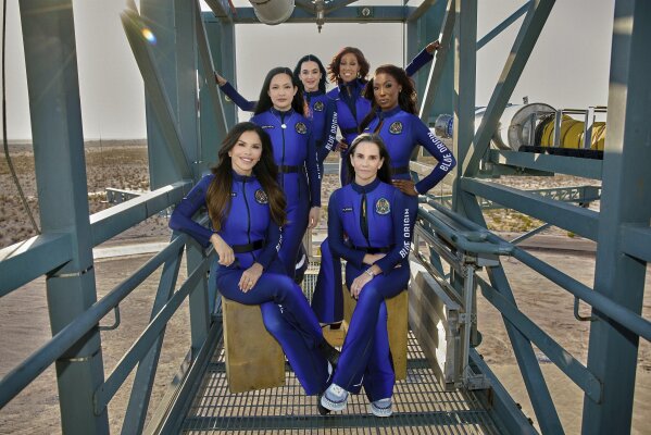 This image provided by Blue Origin shows, first row, seated, from left: Lauren Sanchez and Kerianne Flynn and standing in back from left: Amanda Nguyen, Katy Perry, Gayle King and Aisha Bowe in West Texas. (Blue Origin via AP)