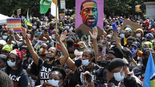 FILE - People participate in a Caribbean-led Black Lives Matter rally on June 14, 2020, at Brooklyn's Grand Army Plaza in New York. On Wednesday, July 19, 2023, New York City agreed to pay more than $13 million to settle a civil rights lawsuit brought on behalf of roughly 1,300 people who were arrested or beaten by police during racial injustice demonstrations that swept through the city during the summer of 2020. (AP Photo/Kathy Willen, File)