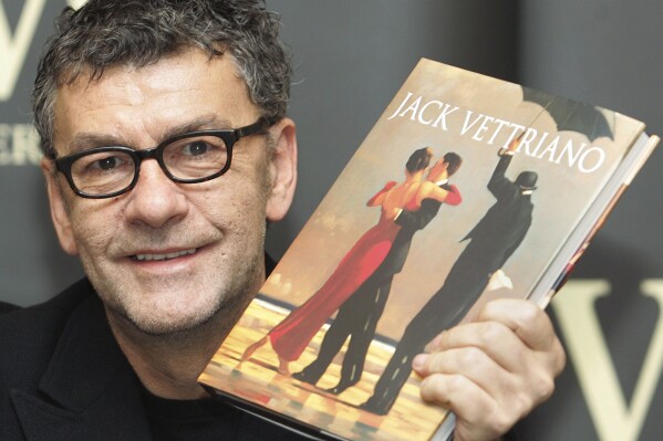 Scottish artist Jack Vettriano holds up a copy of his new book ahead of a signing session held at a London bookstore, Friday Oct. 29, 2004. (AP Photo/Richard Lewis, File)