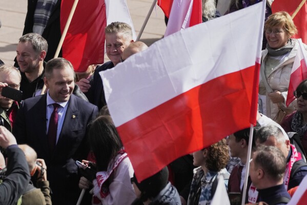 Right-wing candidate Karol Nawrocki, left, takes part in a patriotic demonstration celebrating 1,000 years since the coronation of the first Polish king, Saturday, April 12, 2025 ,in Warsaw, Poland. (AP Photo/Czarek Sokolowski, File)