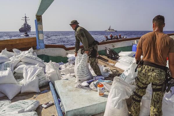 In this photo released by the U.S. Navy, sailors inventory urea and ammonium perchlorate found on a dhow intercepted in the Gulf of Oman on Nov. 9, 2022. The U.S. Navy said Tuesday, Nov. 15, 2022, it found 70 tons of a missile fuel component hidden among bags of fertilizer aboard a ship bound to Yemen from Iran, the first-such seizure in that country's yearslong war as a cease-fire there has broken down. (Sonar Technician 1st Class Kevin Frus/U.S. Navy via AP)