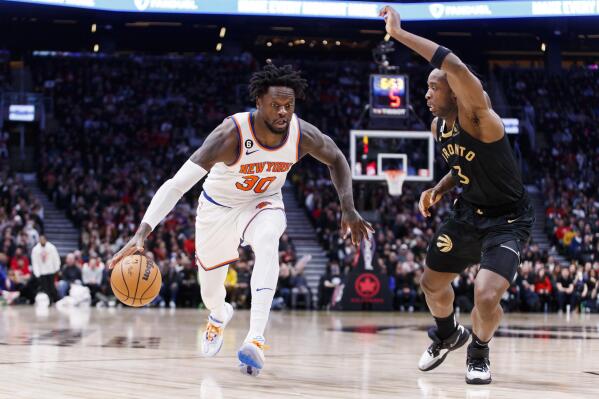 New York Knicks forward Julius Randle (30) drives to the basket against Toronto Raptors forward O.G. Anunoby (3) during the second half of an NBA basketball game Friday, Jan. 6, 2023, in Toronto. (Cole Burston/The Canadian Press via AP)