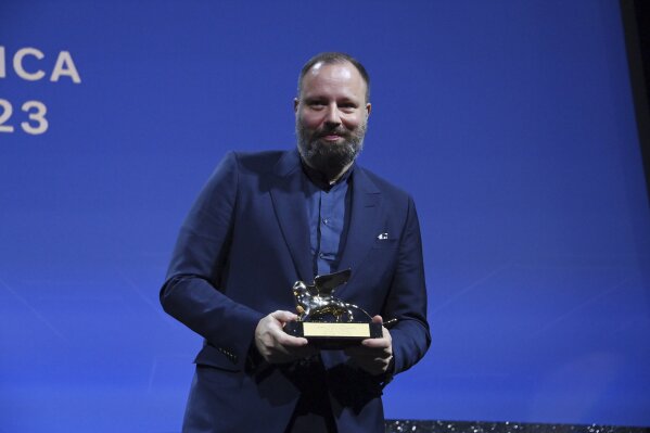 Greek director Yorgos Lanthimos poses with the 'Golden Lion' award for the best film 'Poor Things' during the closing ceremony for the 80th edition of the Venice Film Festival in Venice, Italy, Saturday, Sept. 9, 2023. (Gian Mattia D'Alberto/LaPresse via AP)